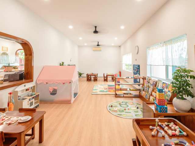 A wooden playhouse inside a classroom at Orange Crest Preschool