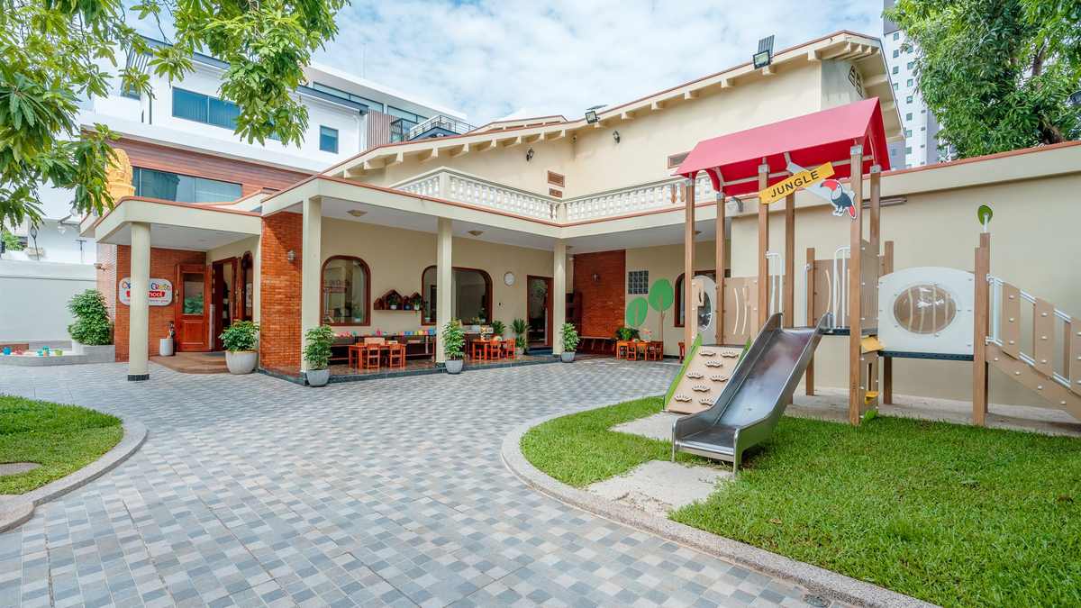 The courtyard and play area at Orange Crest Preschool, with the covered walkway and climbing frame