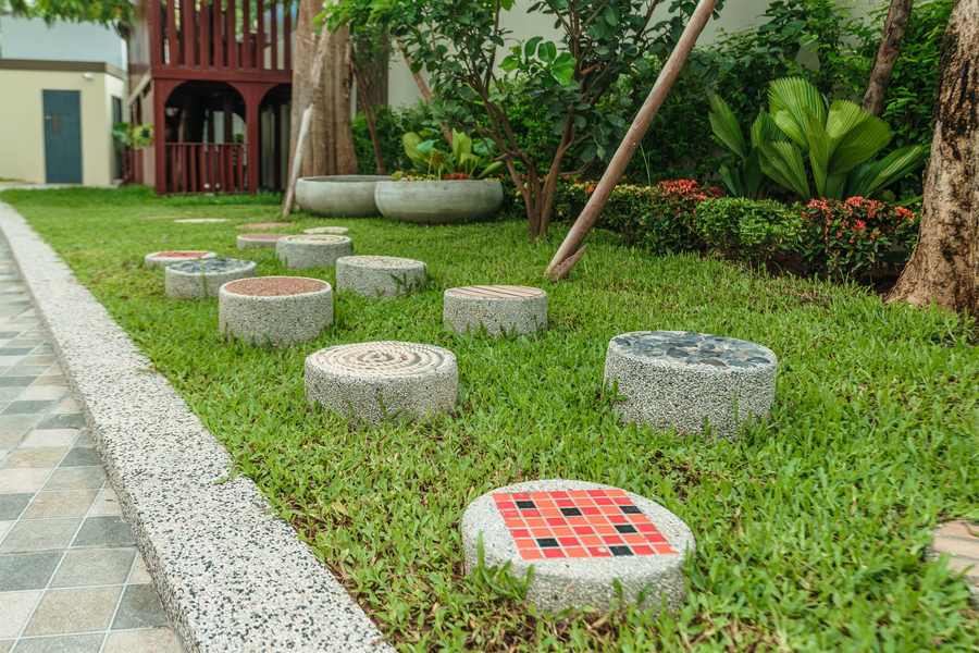 Stepping stones set into the lawn winding between planting beds at Orange Crest Preschool