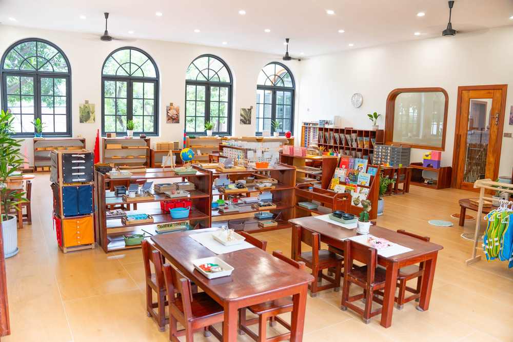 Montessori materials set out in order on open timber shelves in a classroom at Orange Crest Preschool