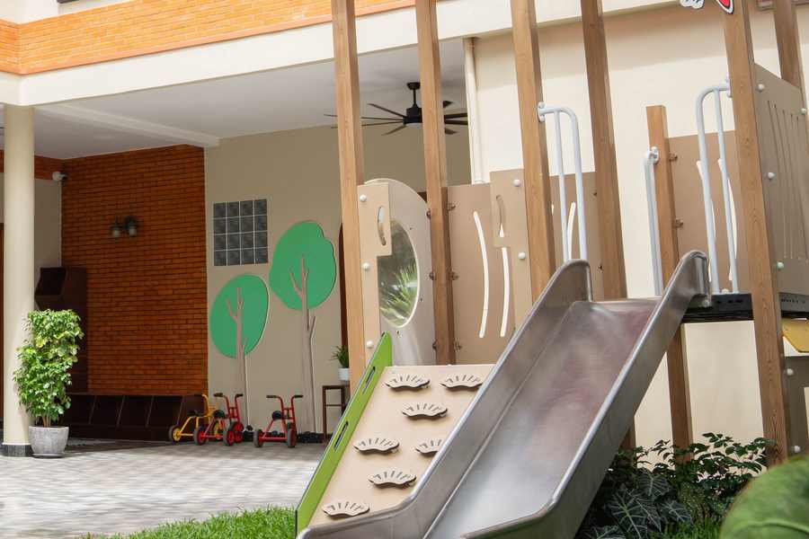 The metal slide and climbing frame on the lawn of the renovated courtyard at Orange Crest Preschool