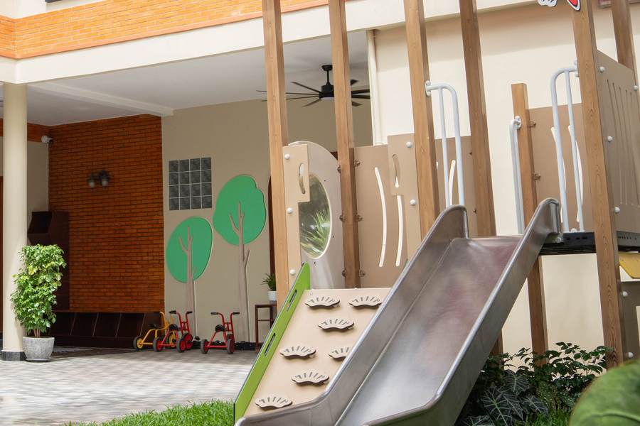 The metal slide and climbing frame on the lawn of the renovated courtyard at Orange Crest Preschool