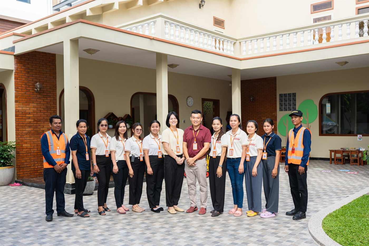 The staff team of Orange Crest Preschool standing together outside the school entrance