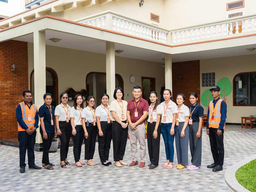 The staff team of Orange Crest Preschool standing together outside the school